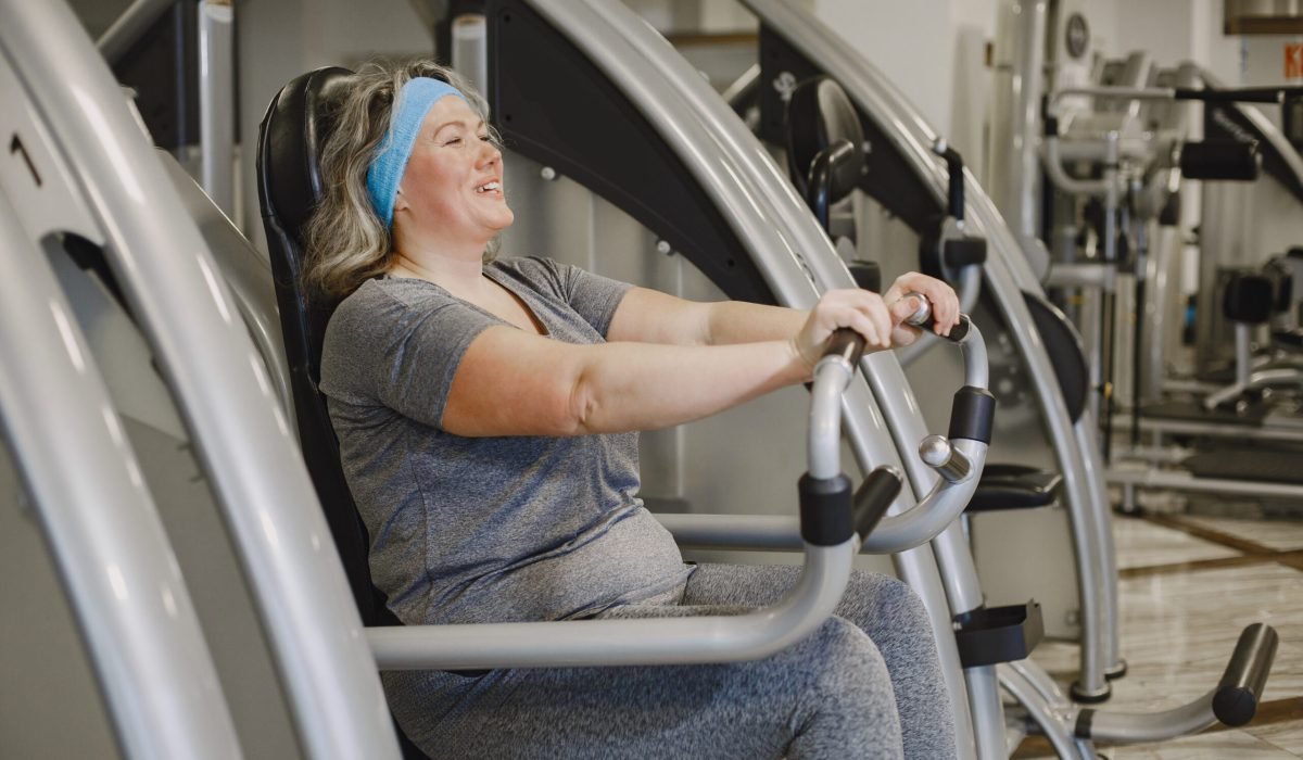 Fat woman dieting, fitness. Portrait of obese woman working out in gym.