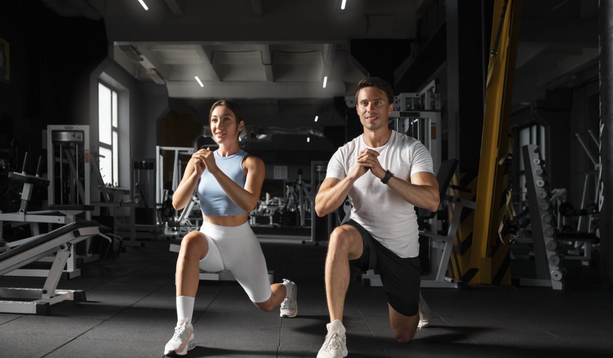 woman-helping-man-gym